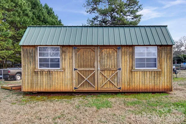 a view of a backyard with wooden fence