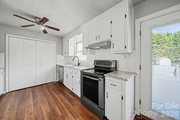 a view of a kitchen with electric appliances