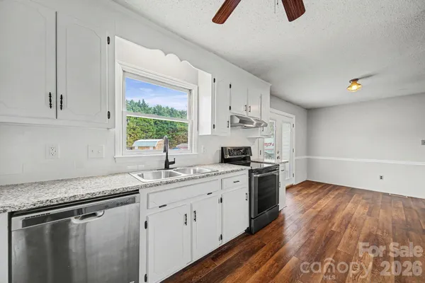 a kitchen with a sink appliances and cabinets