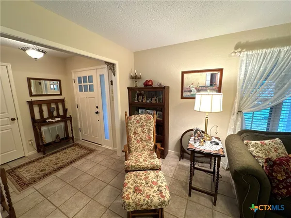 a living room with furniture and floor to ceiling window