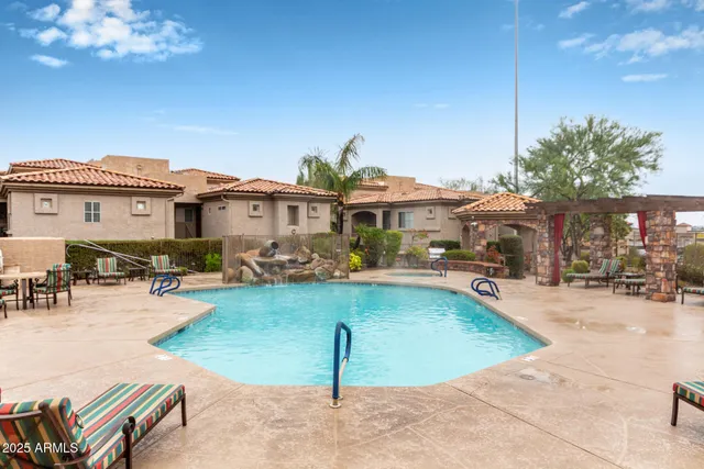 swimming pool view with a seating space