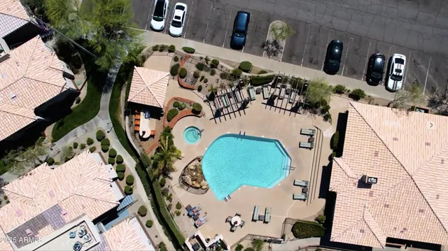 an empty room with wooden floor ceiling fan and windows