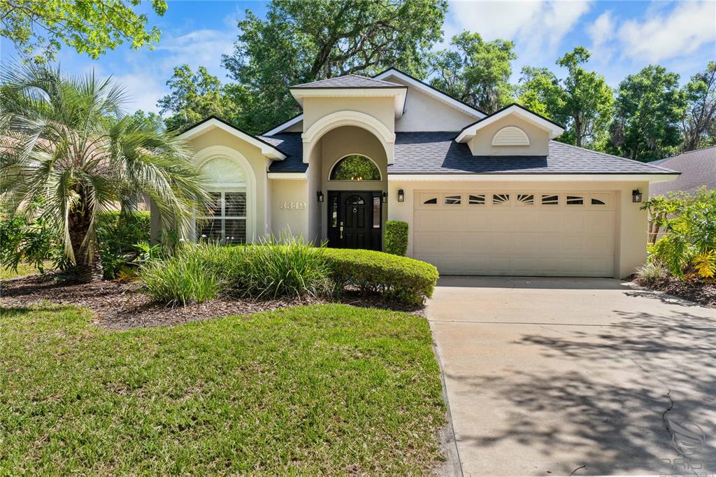 a view of a white house with a yard and plants