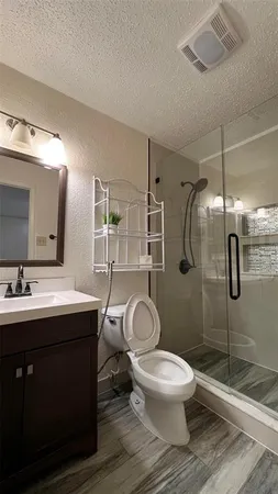 a bathroom with a toilet sink and shower