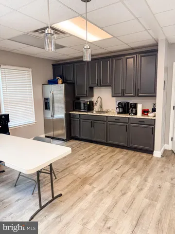 a kitchen with refrigerator and cabinets