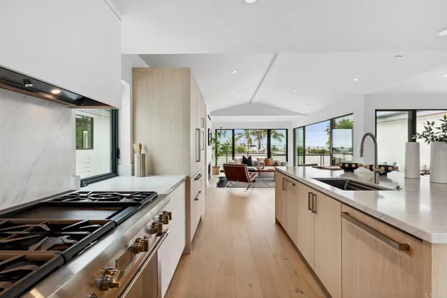 a kitchen with sink stove and cabinets