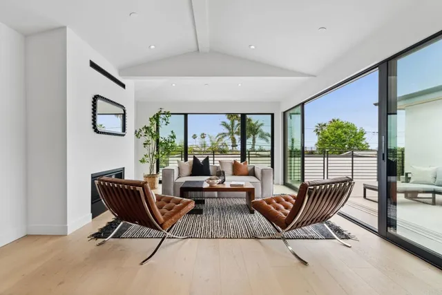 a living room with furniture and a floor to ceiling window