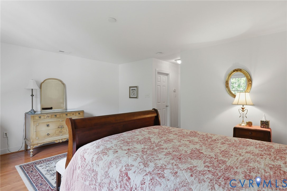 13424 Tipple Point Road Midlothian, VA 23114 - Photo 33 of 53 a bedroom with a bed and a chandelier
