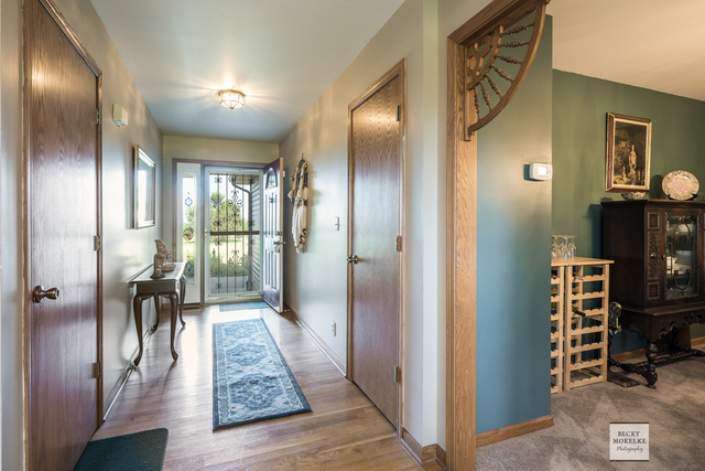 5545 Nettle Creek Road Morris, IL 60450 - Photo 22 of 45 a view of a hallway with wooden floor windows and livingroom
