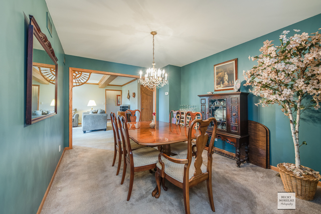 5545 Nettle Creek Road Morris, IL 60450 - Photo 23 of 45 a dining room with furniture a livingroom and chandelier