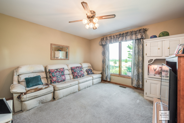 5545 Nettle Creek Road Morris, IL 60450 - Photo 32 of 45 a living room with furniture and a chandelier