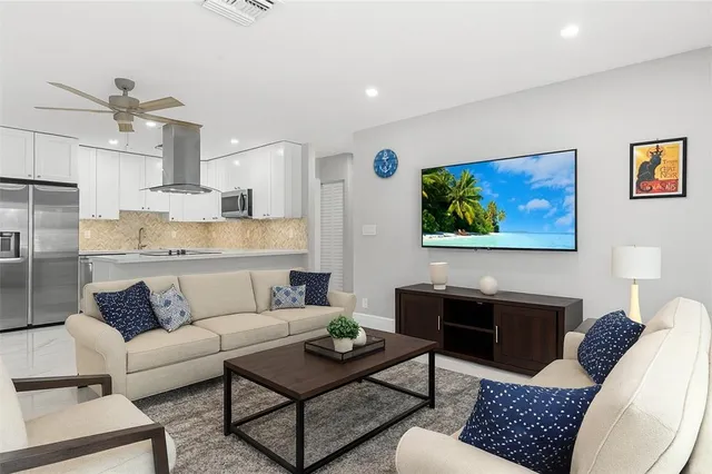 a bedroom with a bed a potted plant on the dresser and floor