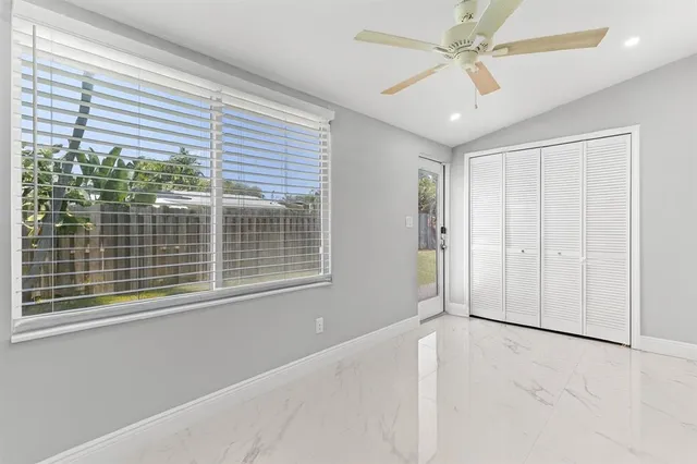 a large bedroom with a bed and a chandelier