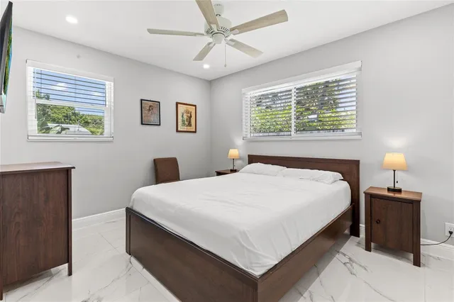 an aerial view of residential house with outdoor space and trees all around