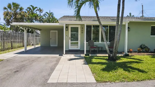 a kitchen with kitchen island stainless steel appliances a sink a stove a refrigerator a sink dishwasher with a dining table and chairs