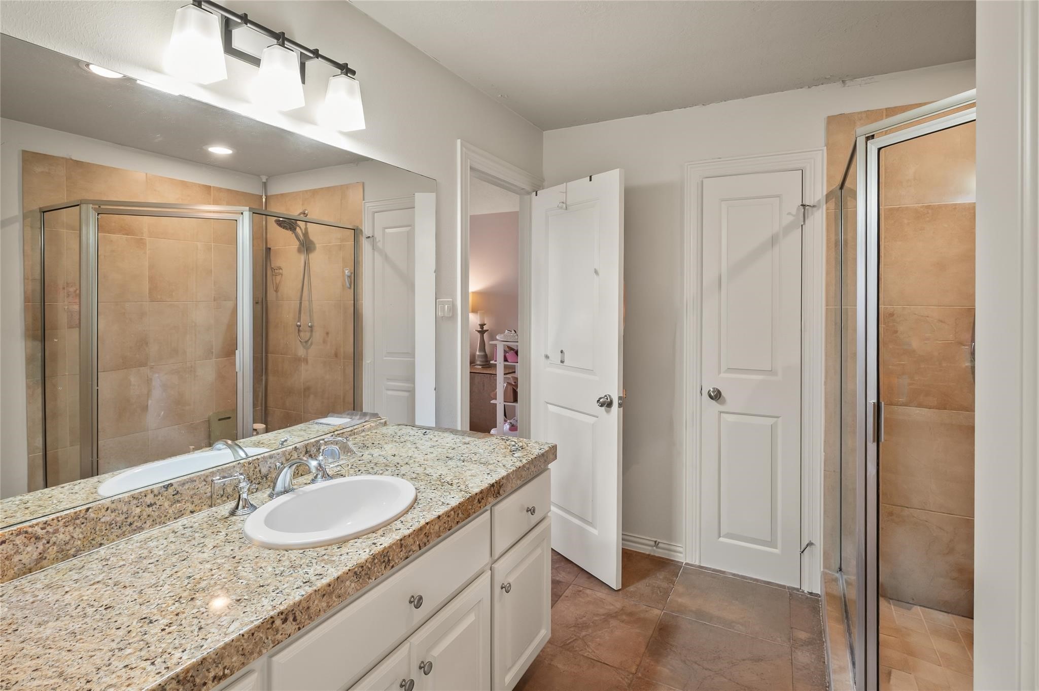 2127 Thicket Ridge Lane Houston, TX 77077 - Photo 25 of 50 This ensuite bathroom is for the large upstairs bathroom. Notice the large walk in shower.