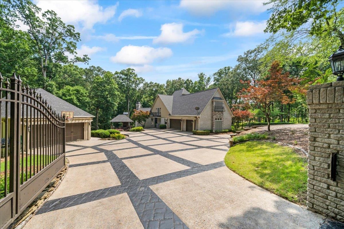 10951 Raleigh Lagrange Road East Eads, TN 38028 - Photo 3 of 40 English style home with roof with shingles, view of scattered trees, and driveway