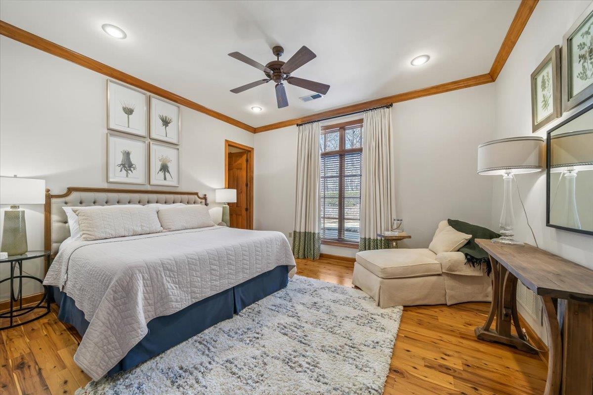 10951 Raleigh Lagrange Road East Eads, TN 38028 - Photo 35 of 40 a spacious bedroom with a bed a couch and a ceiling fan