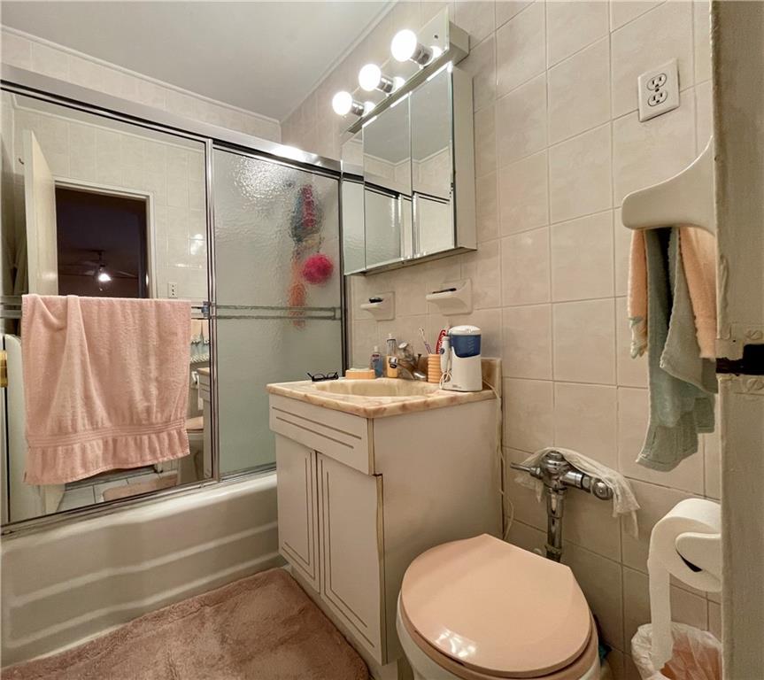 1200 Gravesend Neck Road, Unit 3B Brooklyn, NY 11229 - Photo 11 of 13 a bathroom with a sink a toilet and shower