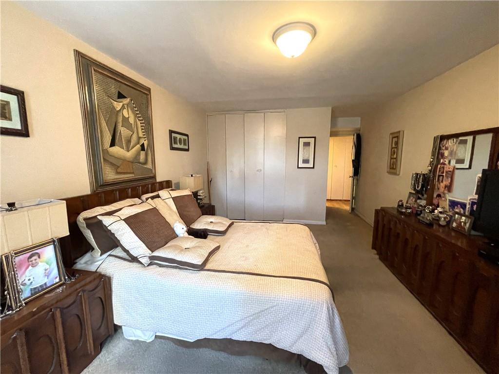 1200 Gravesend Neck Road, Unit 3B Brooklyn, NY 11229 - Photo 13 of 13 a bedroom with a bed and wooden floor