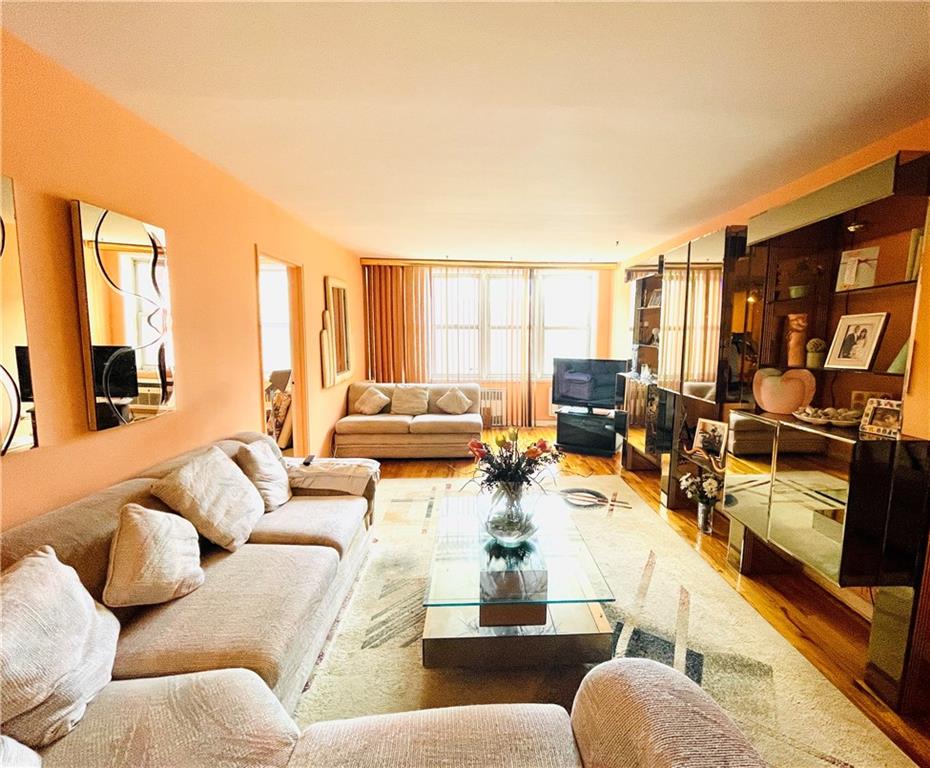 1200 Gravesend Neck Road, Unit 3B Brooklyn, NY 11229 - Photo 2 of 13 a living room with furniture and a large window