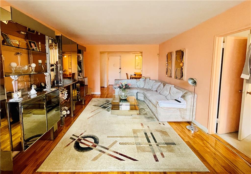 1200 Gravesend Neck Road, Unit 3B Brooklyn, NY 11229 - Photo 3 of 13 a living room with furniture stove and a table