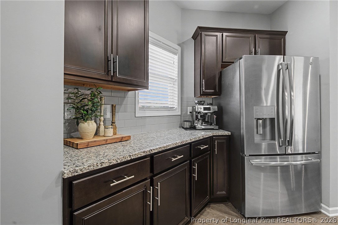 143 Ledgebrook Lane Raeford, NC 28376 - Photo 20 of 50 a kitchen with granite countertop a refrigerator and a sink