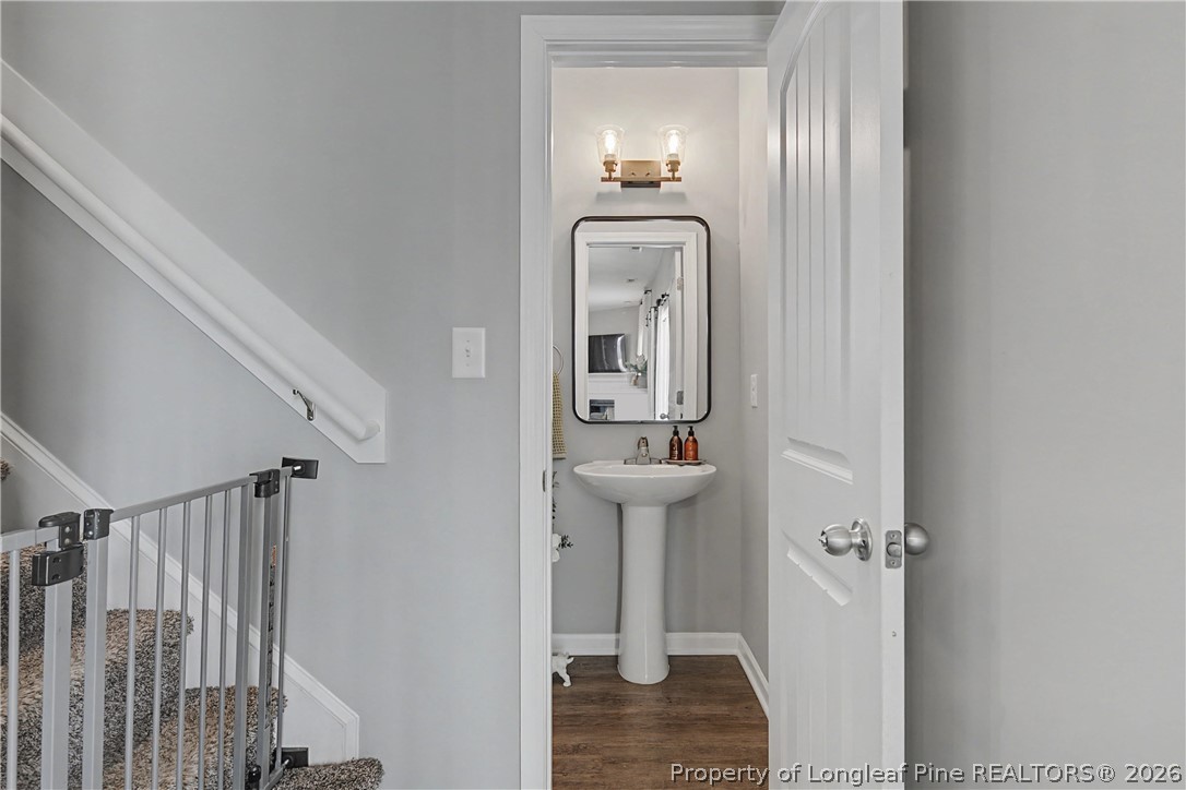 143 Ledgebrook Lane Raeford, NC 28376 - Photo 25 of 50 a bathroom with a light fixture a mirror and a sink