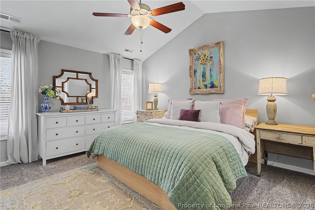 143 Ledgebrook Lane Raeford, NC 28376 - Photo 26 of 50 a bedroom with a bed and a chandelier