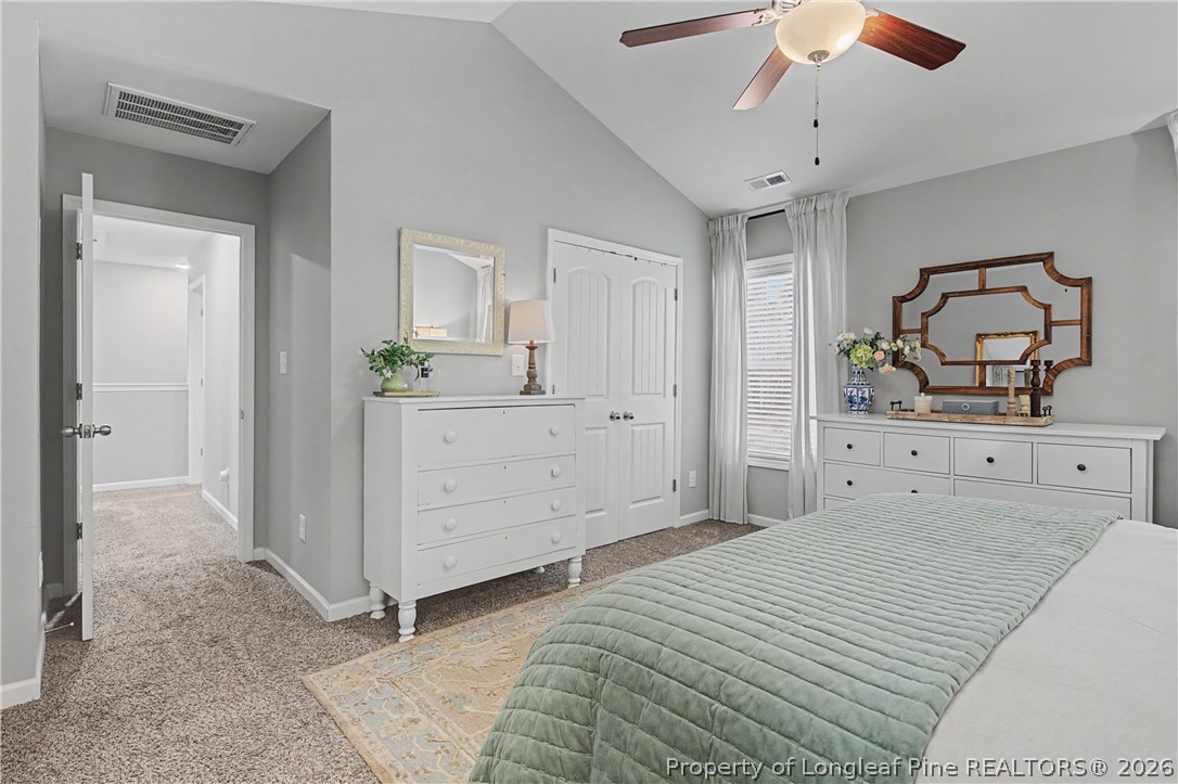 143 Ledgebrook Lane Raeford, NC 28376 - Photo 29 of 50 a bedroom with a large bed and a chandelier
