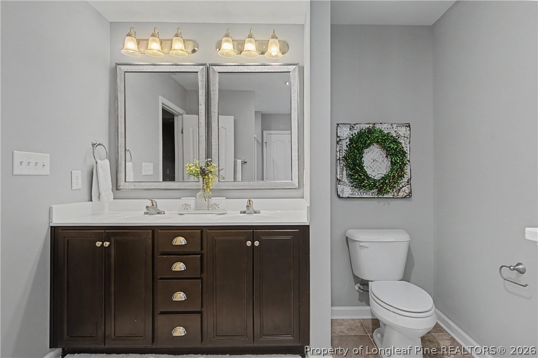 143 Ledgebrook Lane Raeford, NC 28376 - Photo 31 of 50 a bathroom with a toilet sink and mirror