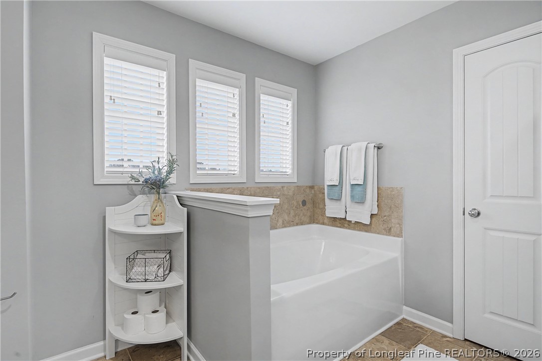 143 Ledgebrook Lane Raeford, NC 28376 - Photo 32 of 50 a bathroom with a bathtub sink and mirror
