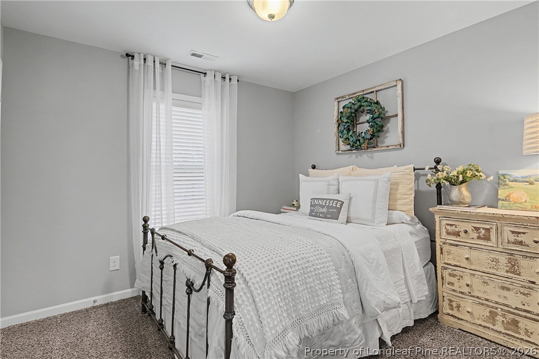 143 Ledgebrook Lane Raeford, NC 28376 - Photo 34 of 50 a bedroom with a bed a baby and a window