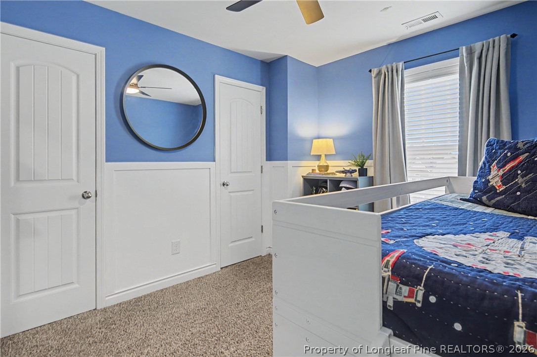 143 Ledgebrook Lane Raeford, NC 28376 - Photo 40 of 50 a bedroom with a bed and a chandelier