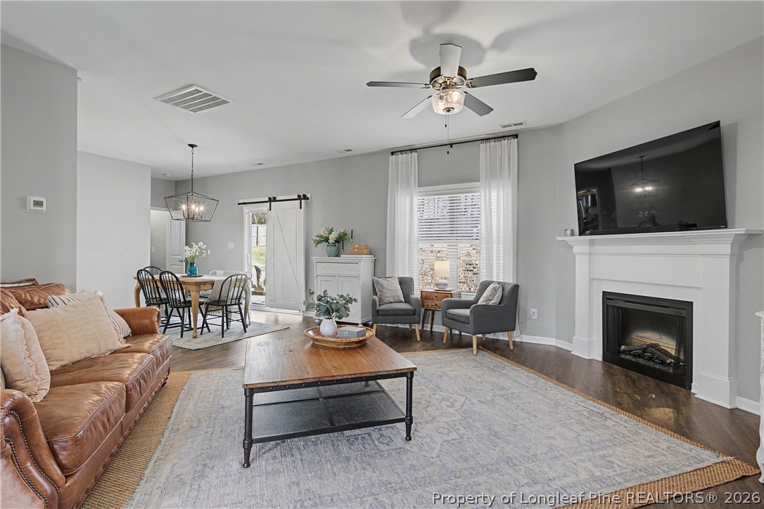 143 Ledgebrook Lane Raeford, NC 28376 - Photo 7 of 50 a living room with furniture a flat screen tv and a fireplace