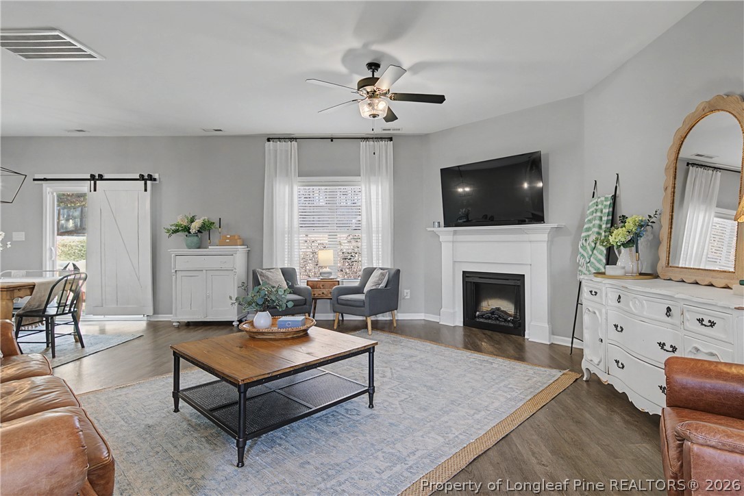143 Ledgebrook Lane Raeford, NC 28376 - Photo 8 of 50 a living room with furniture a flat screen tv and a fireplace