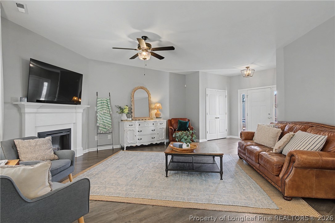 143 Ledgebrook Lane Raeford, NC 28376 - Photo 10 of 50 a living room with furniture a fireplace and a flat screen tv