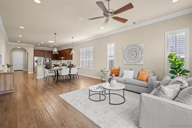 a living room with furniture and kitchen view