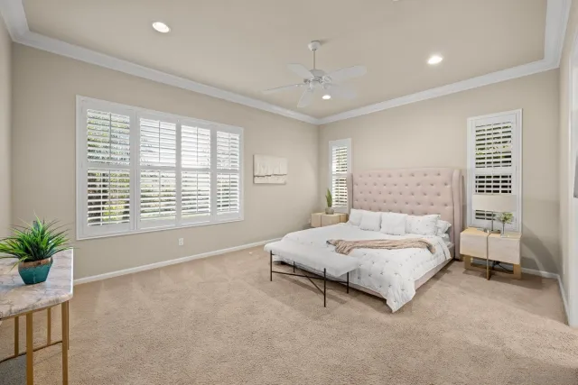 a spacious bedroom with a bed and a window