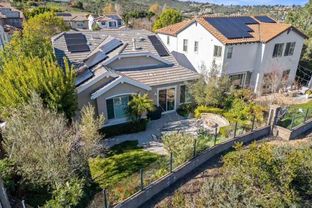 a aerial view of a house with a yard and potted plants