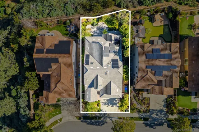 an aerial view of houses with outdoor space