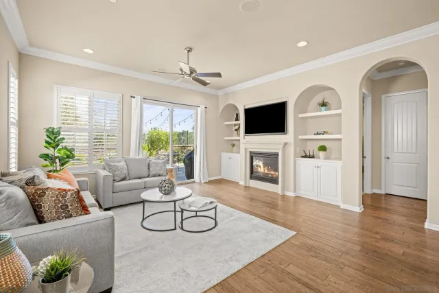 a living room with furniture a fireplace and a flat screen tv