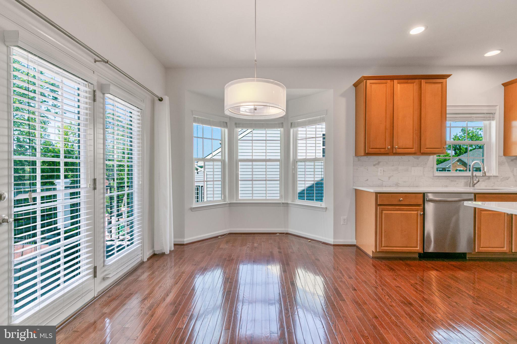 40652 Banshee Drive Leesburg, VA 20175 - Photo 14 of 51 a view of an empty room with window and wooden floor