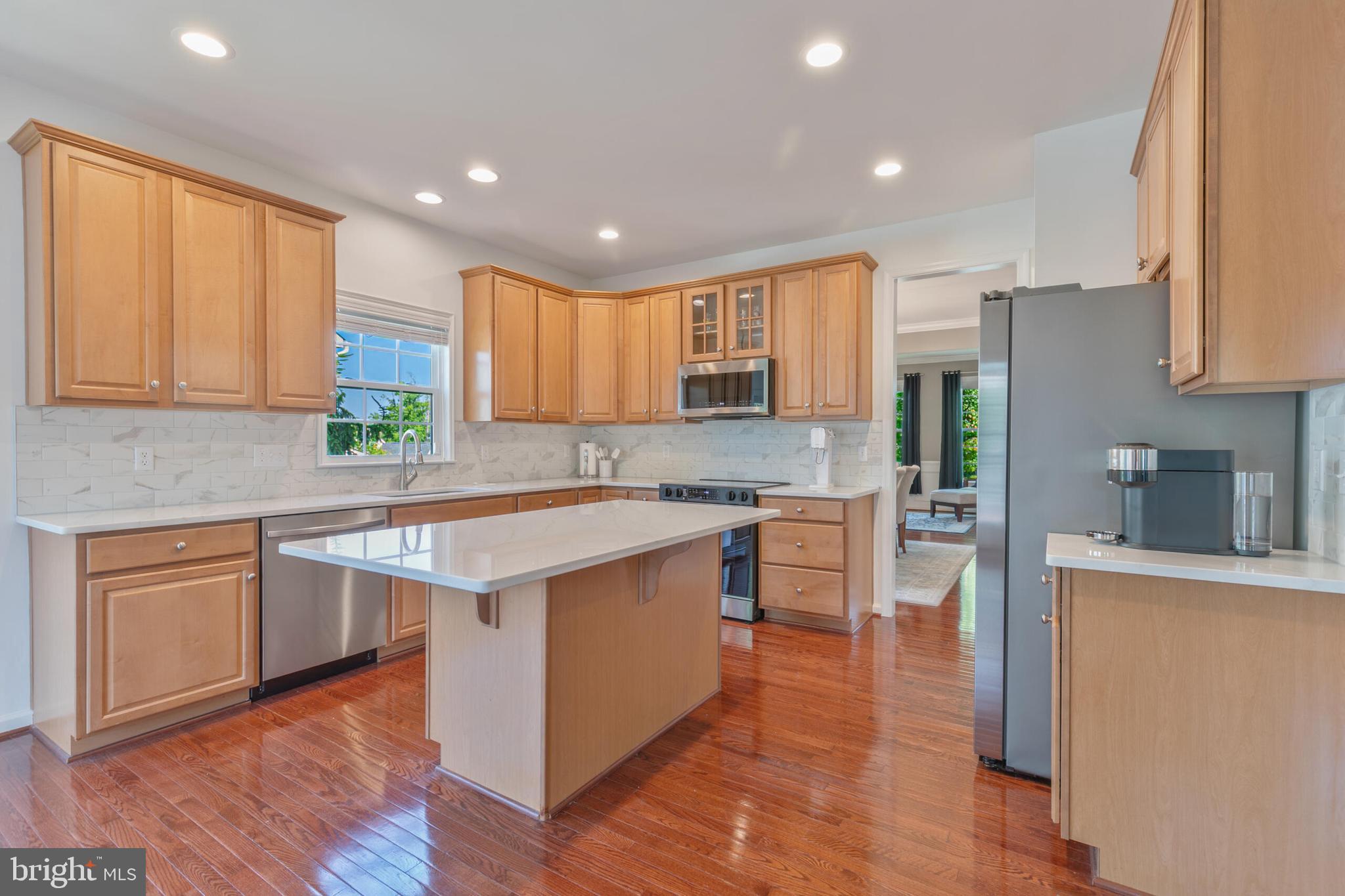40652 Banshee Drive Leesburg, VA 20175 - Photo 15 of 51 a kitchen with stainless steel appliances granite countertop a sink a stove a refrigerator cabinets and a counter top space
