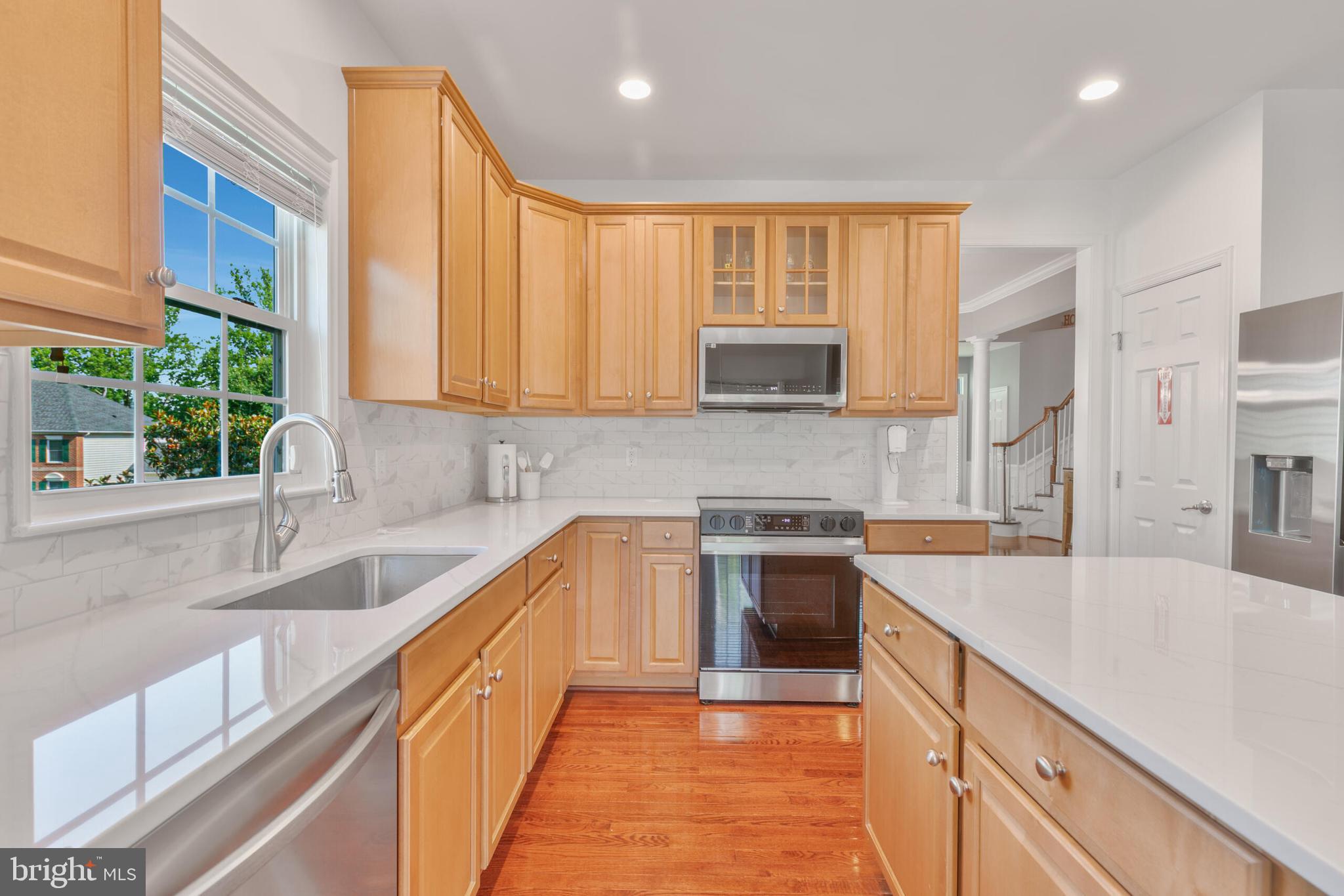 40652 Banshee Drive Leesburg, VA 20175 - Photo 19 of 51 a kitchen with stainless steel appliances granite countertop a sink stove and cabinets