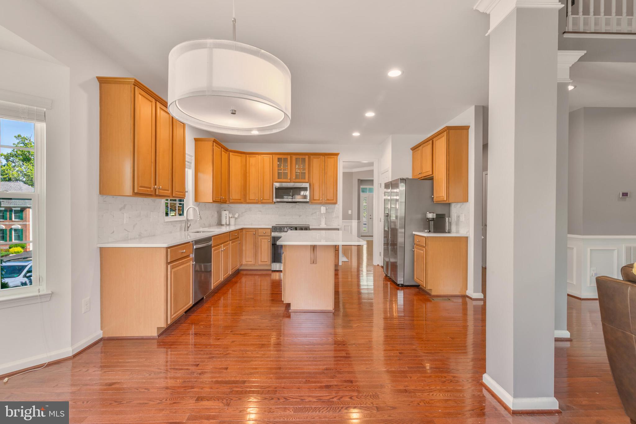 40652 Banshee Drive Leesburg, VA 20175 - Photo 21 of 51 a large white kitchen with a large window and stainless steel appliances