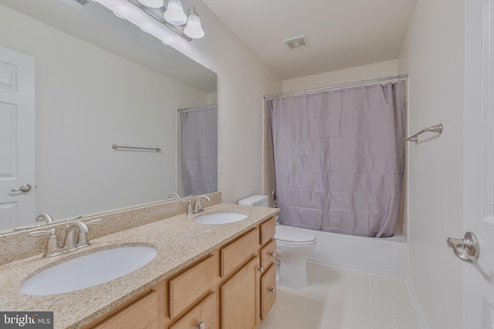 40652 Banshee Drive Leesburg, VA 20175 - Photo 24 of 51 a bathroom with a granite countertop sink and a mirror