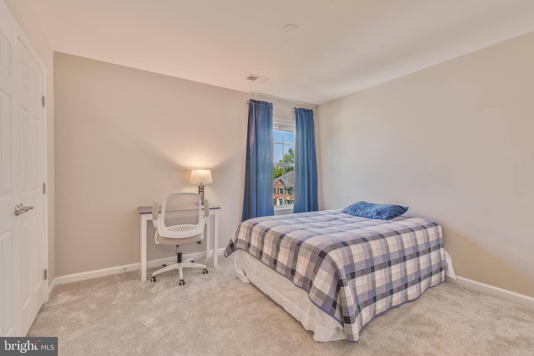 40652 Banshee Drive Leesburg, VA 20175 - Photo 25 of 51 a bedroom with a bed and a chair