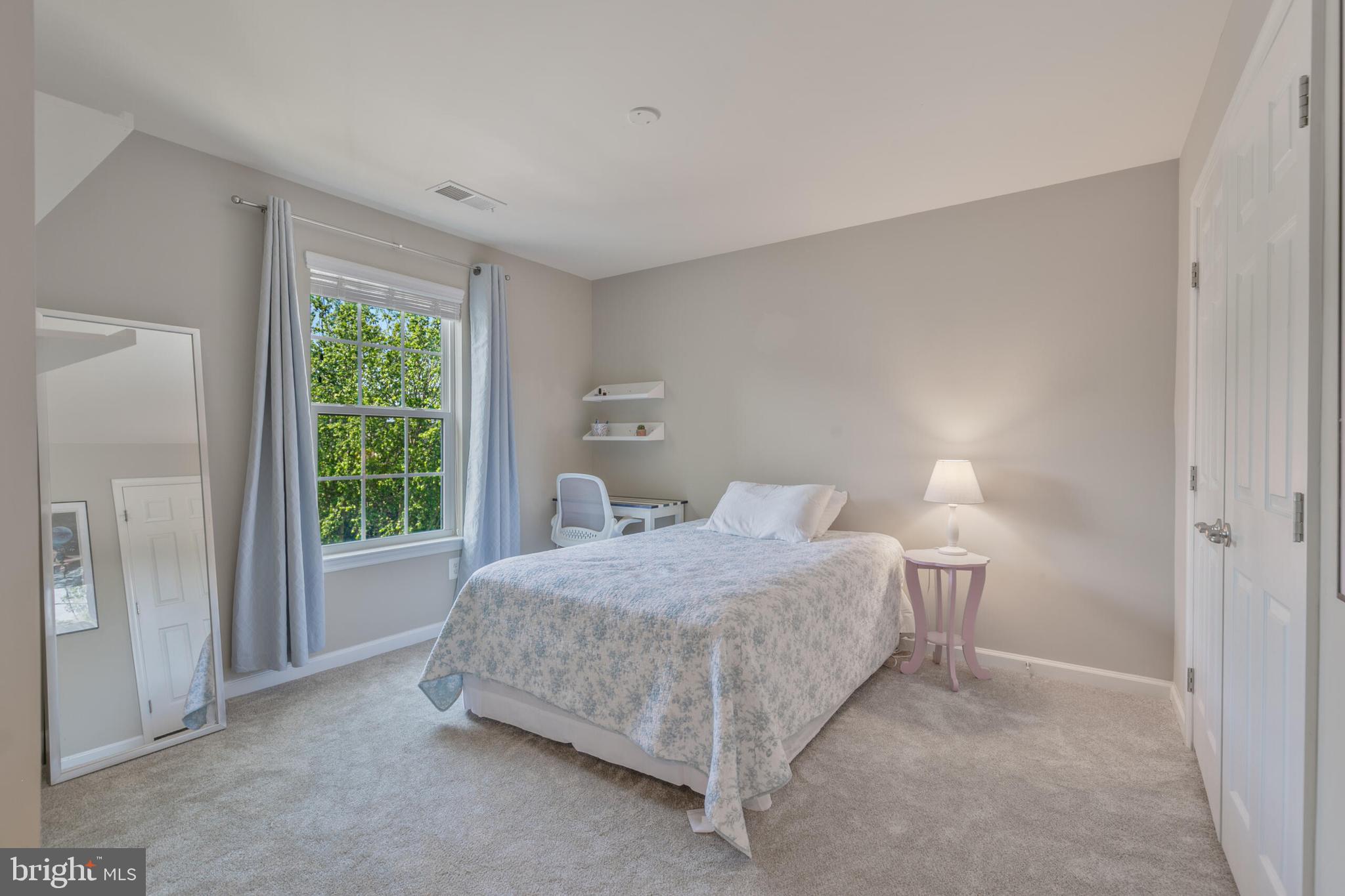 40652 Banshee Drive Leesburg, VA 20175 - Photo 27 of 51 a bedroom with a bed lamp and window