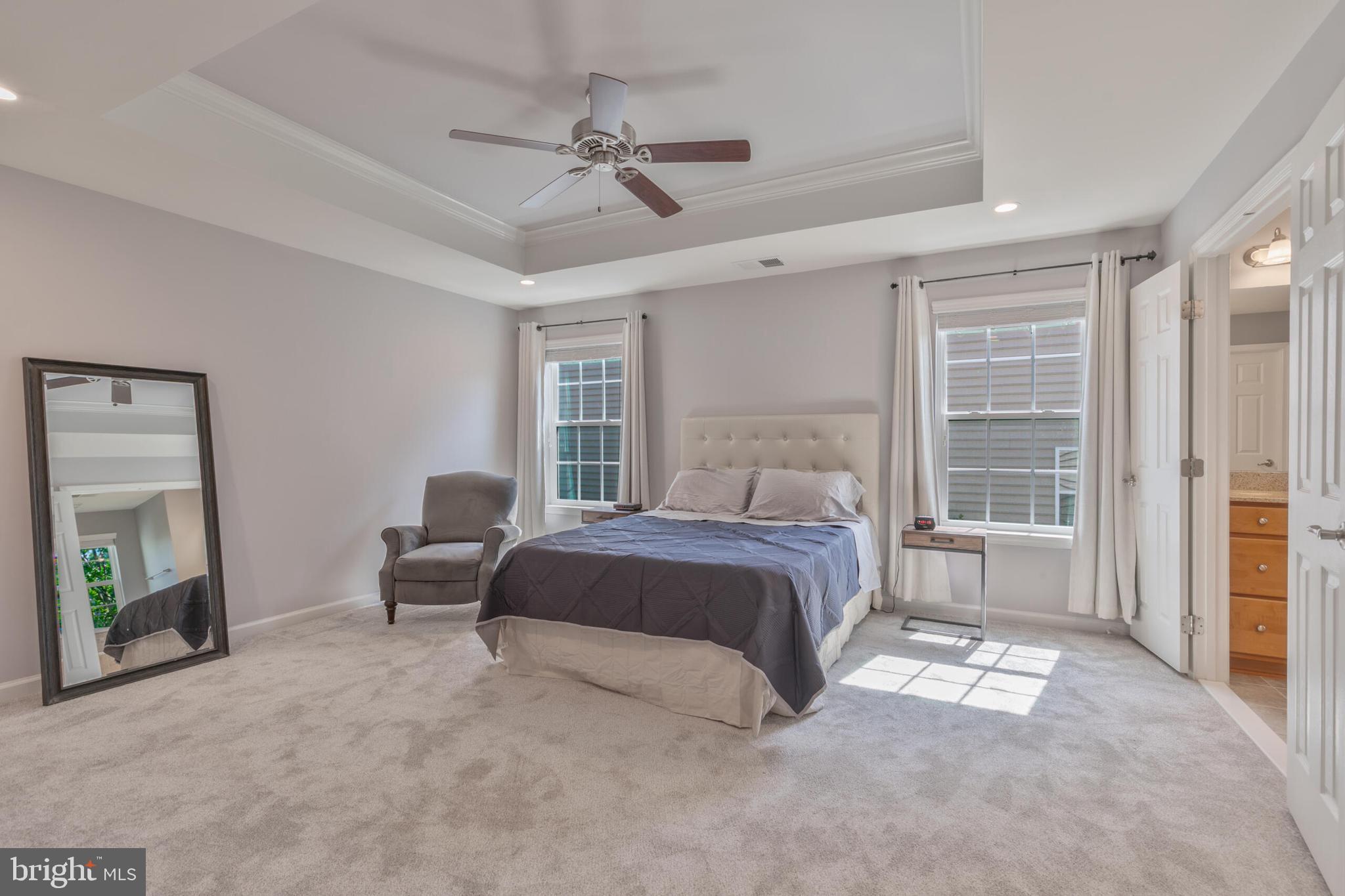 40652 Banshee Drive Leesburg, VA 20175 - Photo 28 of 51 a bedroom with a bed and a chandelier